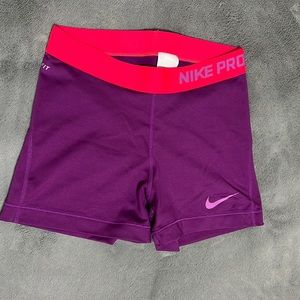 Purple and hot pink womens Nike pro 3” spandex shorts. Size Medium